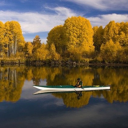 Guy kayaking looking at houses