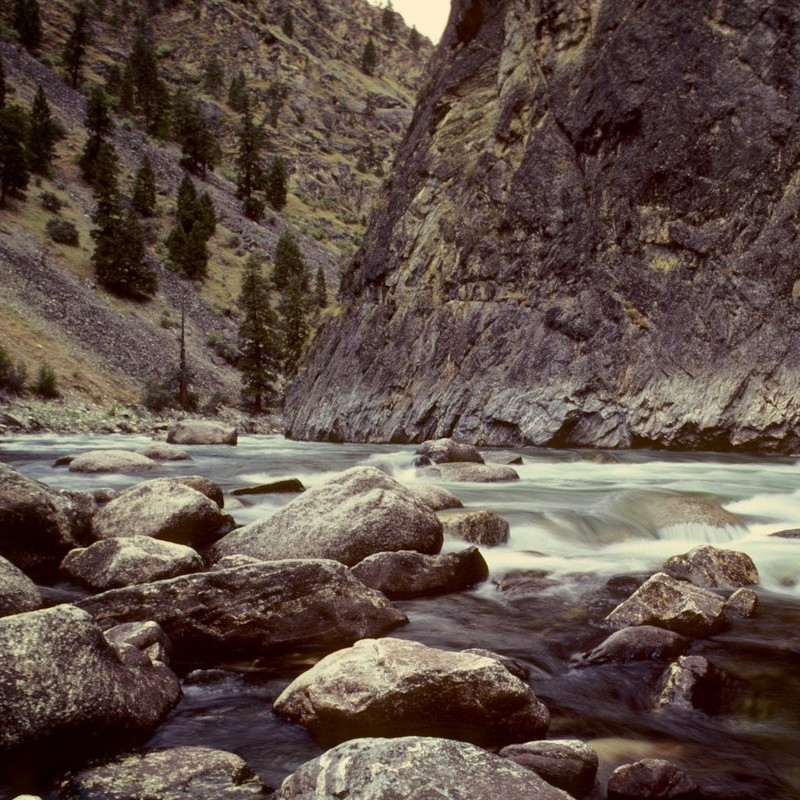 River surrounding by a big Rock